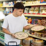 Un chico hace la compra en un supermercado.